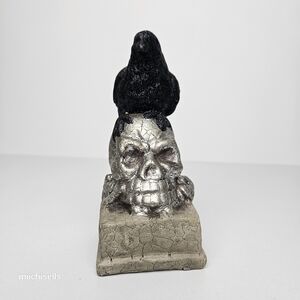 Raven on a skull statue